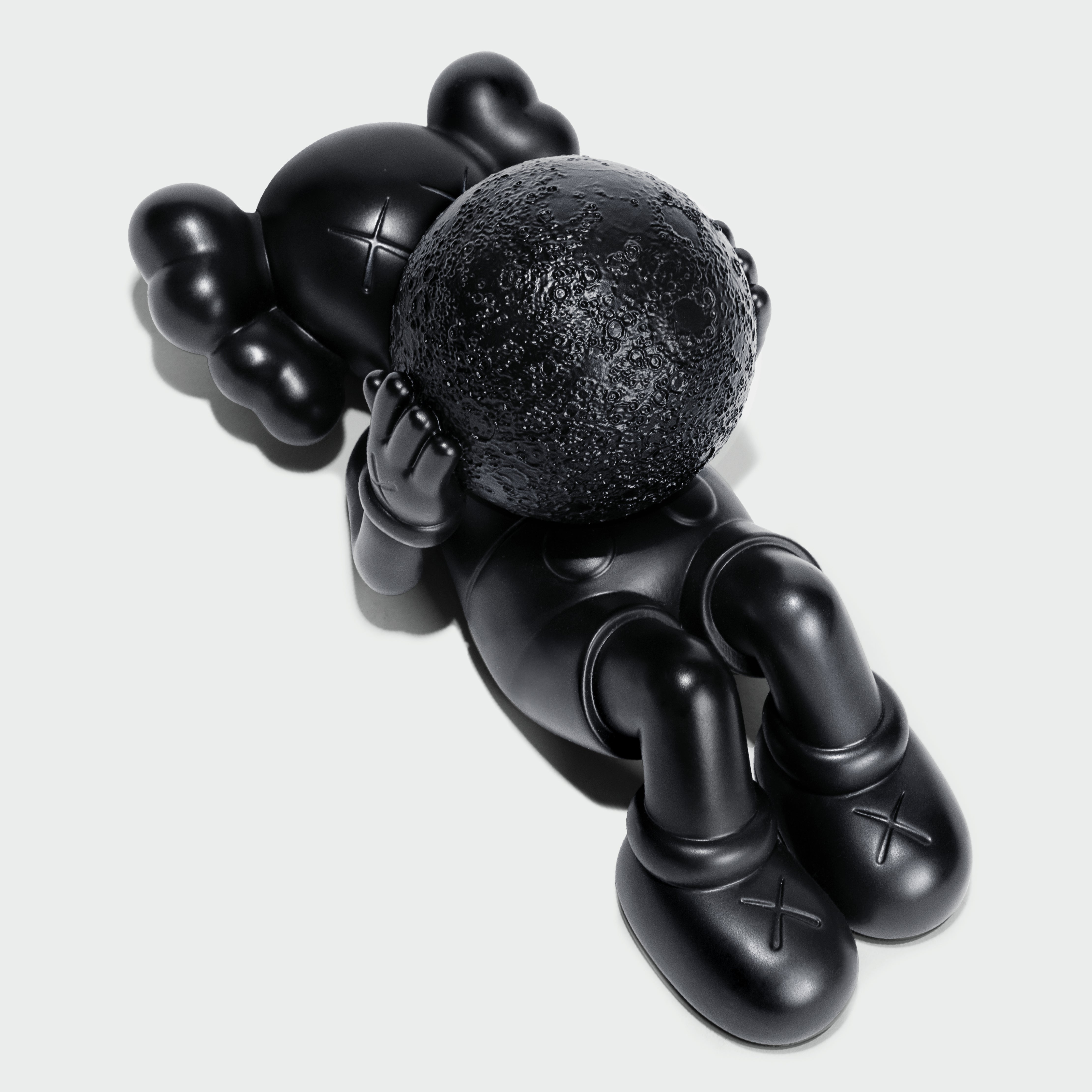 KAWS Calm Night Bronze Sculpture lying down. Side view showing solid bronze material. Includes wooden box and signed COA. Verified authentic by Art Trader.-3