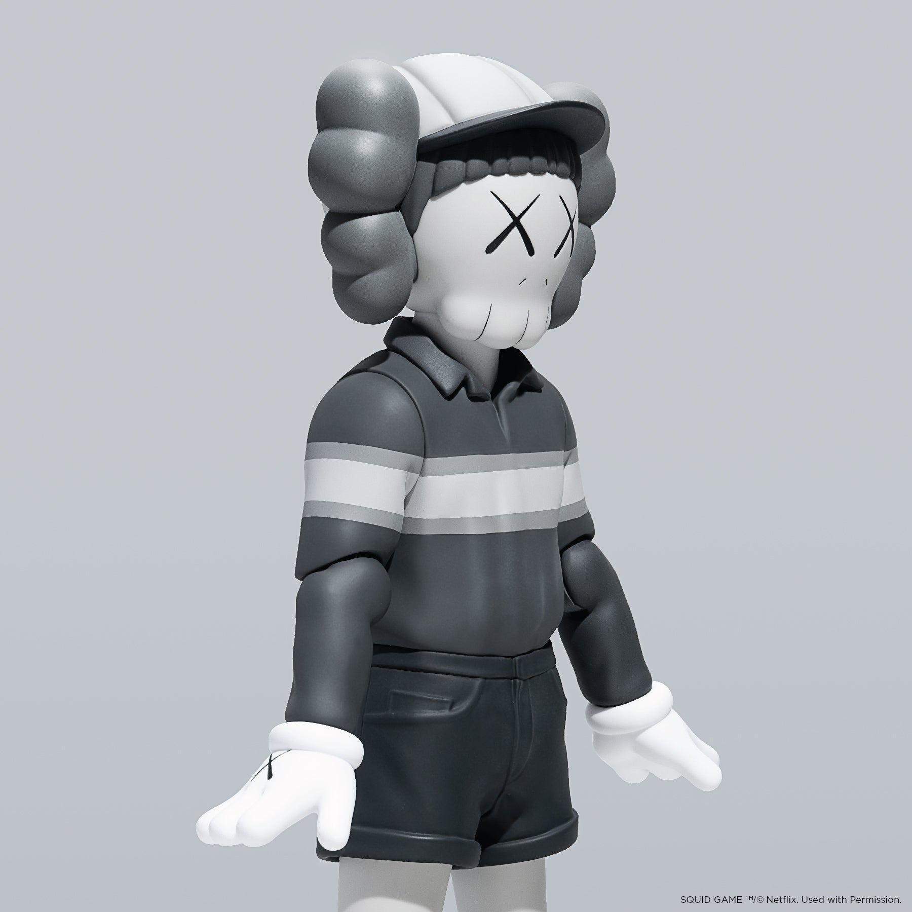 KAWS Chul-Su Monotone Grey Vinyl Figure 2025. Side profile showing NFC tag capability. Authentic art toy verified by Art Trader.-3
