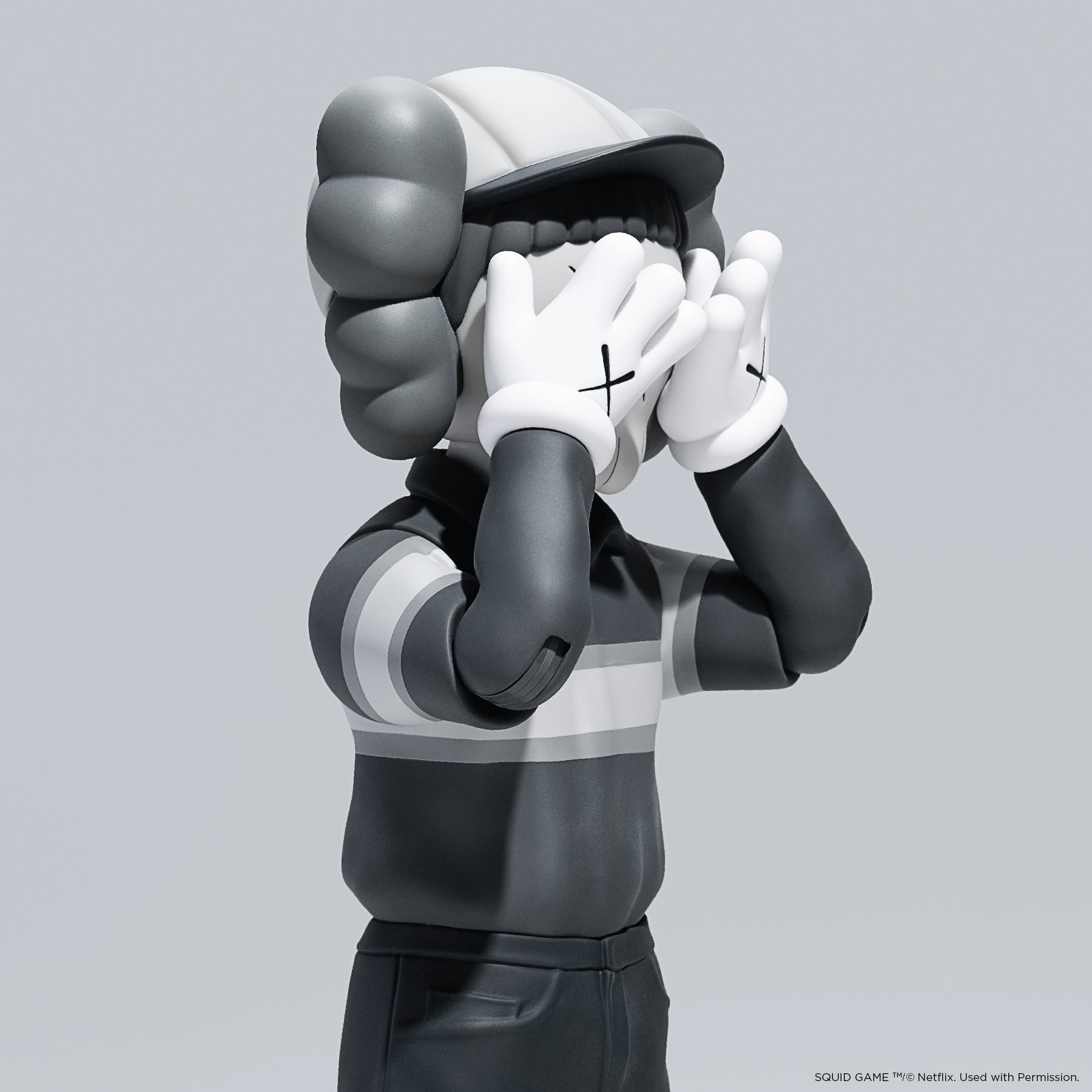 KAWS Chul-Su Monotone Grey Vinyl Figure 2025. Side profile showing NFC tag capability. Authentic art toy verified by Art Trader.-4