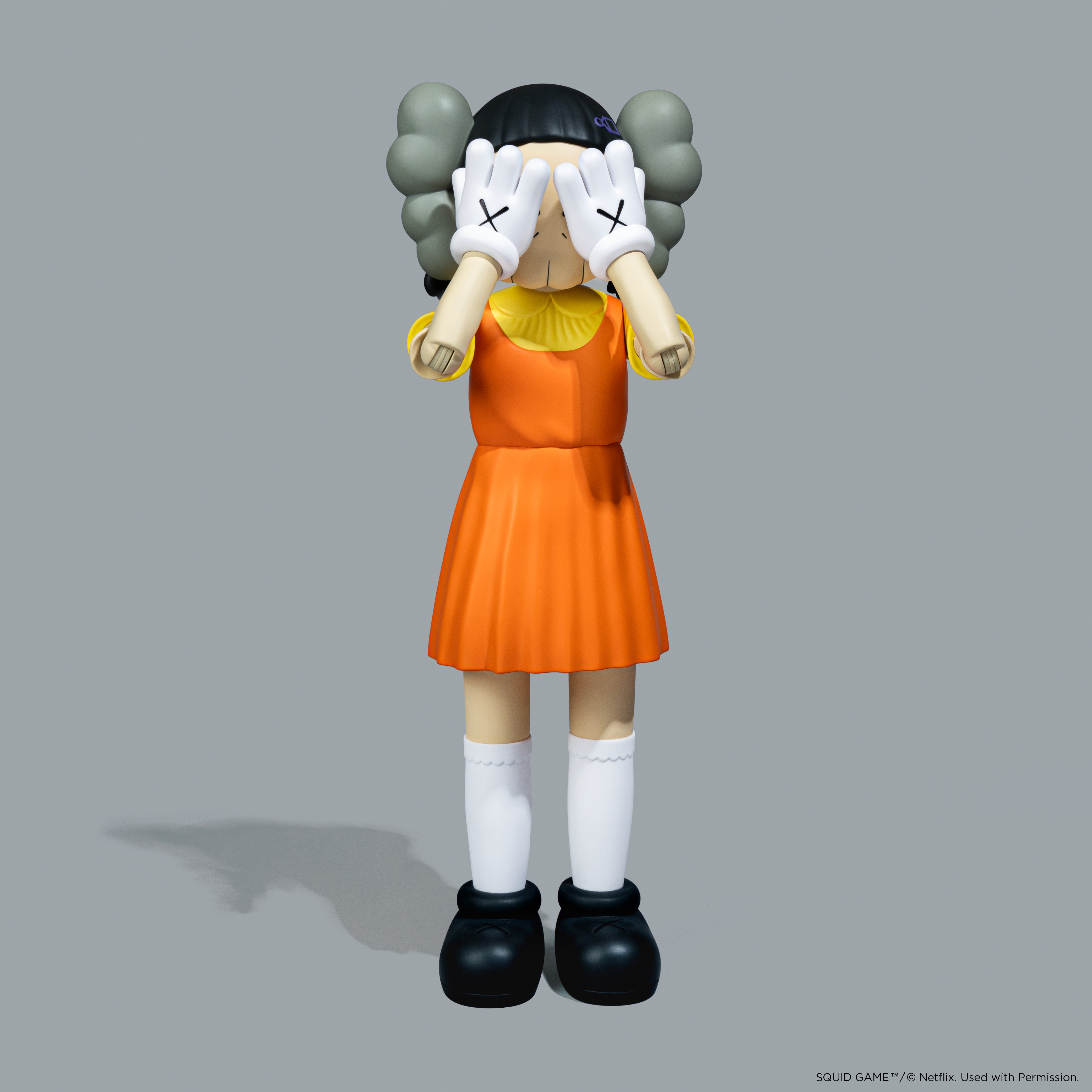 KAWS x Squid Game Young-Hee Coloured Vinyl Figure. Official Netflix collaboration art toy with NFC chip.[5][8] Verified authentic by Art Trader.-2