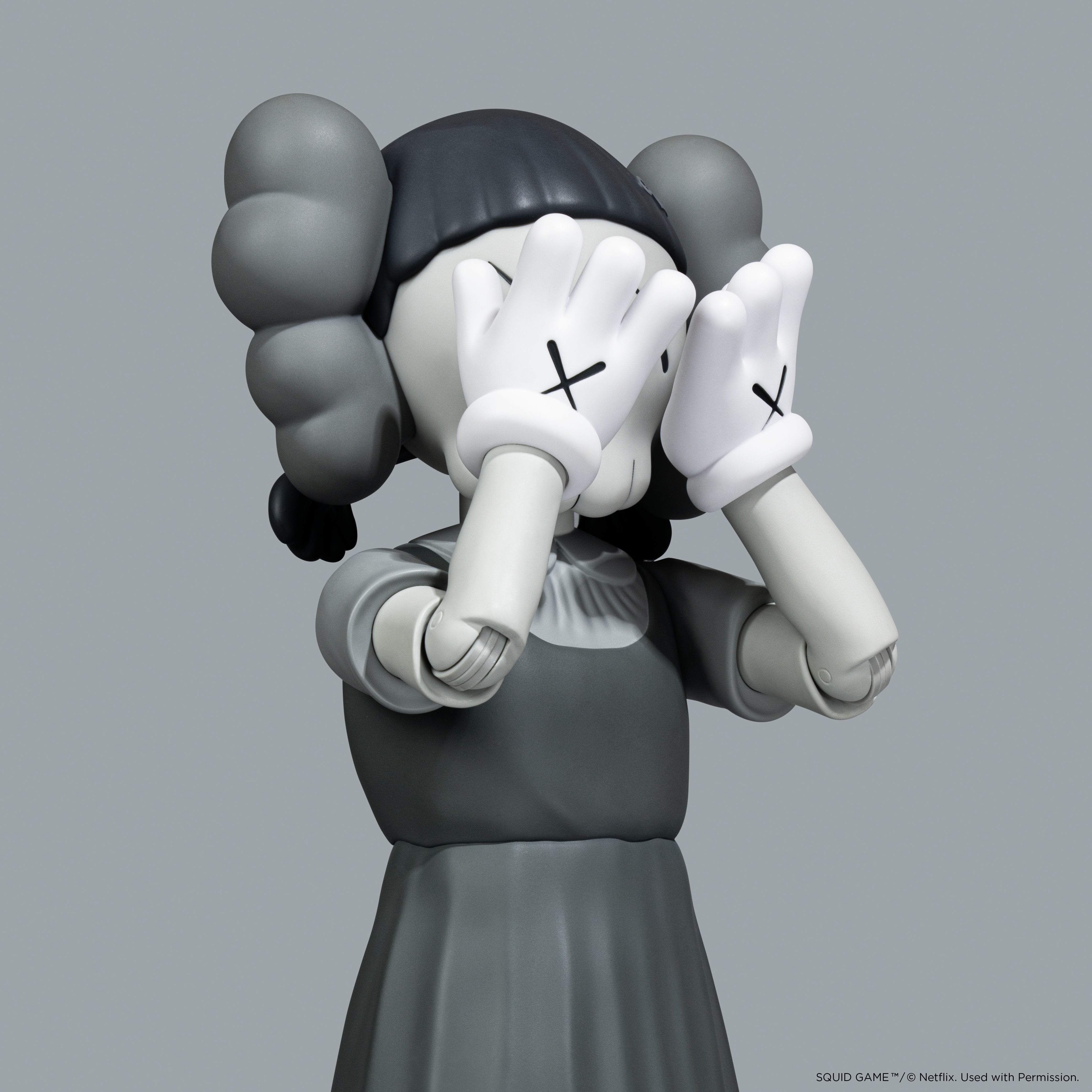 KAWS Squid Game Young-Hee Monotone Grey Vinyl Figure. Minimalist art toy with NFC authentication. Verified authentic by Art Trader.-4