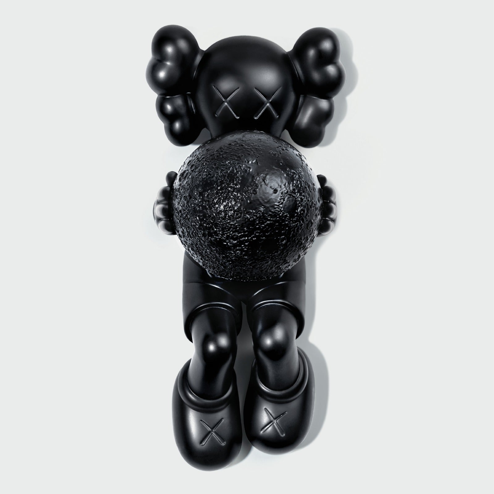 KAWS Calm Night Bronze Sculpture lying down. Side view showing solid bronze material. Includes wooden box and signed COA. Verified authentic by Art Trader.-4